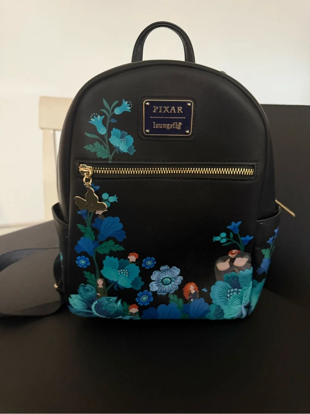 Loungefly Pixar Black Mini Backpack with Blue Floral Print